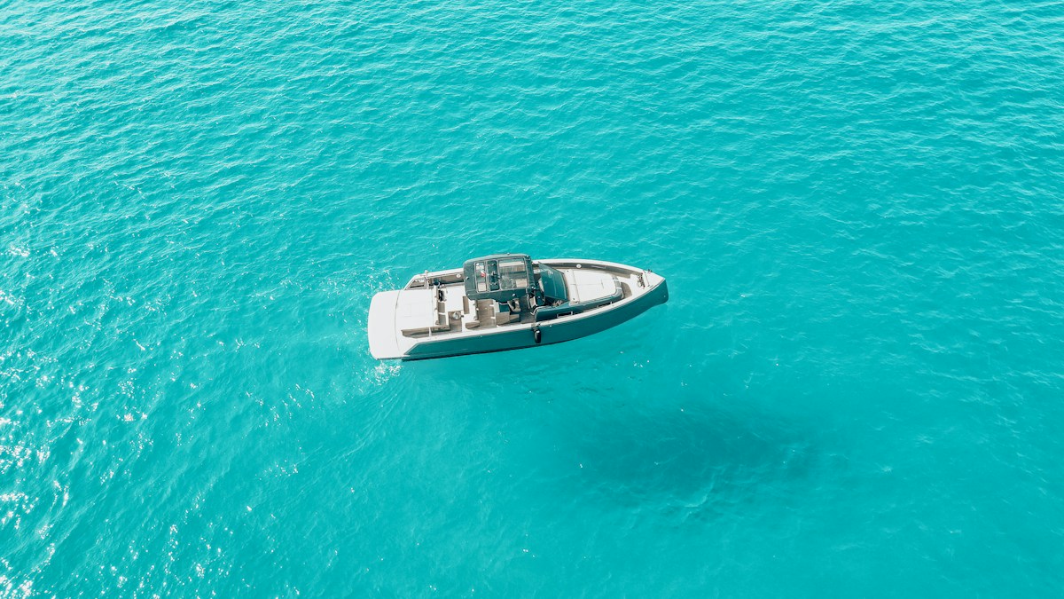A small leisure boat surrounded by clear turquoise sea